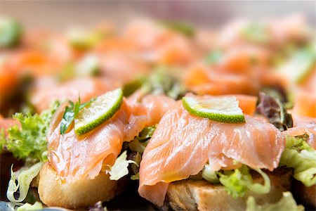 salmon on a colored plate - Image of salmon sandwiches with lime on a serving plate Stock Photo - Budget Royalty-Free & Subscription, Code: 400-07634200