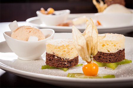 sliced carambola - Gourmet coffee and chocolate blanc mange with a colourful ripe Cape gooseberry and sliced carambola or star fruit served on a plain white plate Photographie de stock - Aubaine LD & Abonnement, Code: 400-07630004