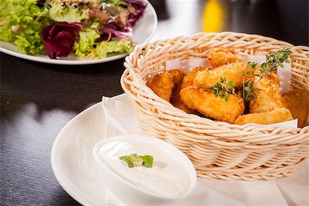 simsearch:400-05708291,k - Crispy fried crumbed chicken nuggets in a wicker basket served as a finger food or appetizer with a creamy dip in a bowl alongside Stock Photo - Budget Royalty-Free & Subscription, Code: 400-07630000