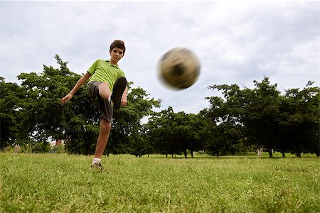 Children playing soccer game in park, with copy space on grass and focus on football ball Stock Photo - Budget Royalty-Free & Subscription, Code: 400-07630755