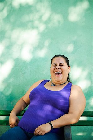 Portrait of overweight hispanic woman looking at camera and smiling Stock Photo - Budget Royalty-Free & Subscription, Code: 400-07630752