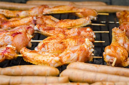 Sausages and chicken wings on the smoking grill barbeque Stock Photo - Budget Royalty-Free & Subscription, Code: 400-07630781