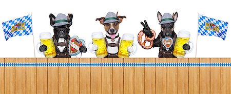 simsearch:400-08163219,k - three bavarian  dogs behind a fence with beer mugs and pretzel bread Photographie de stock - Aubaine LD & Abonnement, Code: 400-07631151