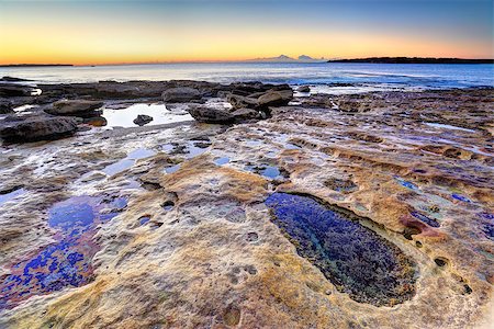 simsearch:400-07667033,k - Beautiful sunrise, a clear morning on the rocks at Cronulla NSW Australia with colourful rocks and rockpools in foreground. Stock Photo - Budget Royalty-Free & Subscription, Code: 400-07631966