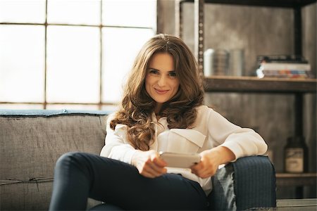 simsearch:400-08054469,k - Happy young woman writing sms in loft apartment Stock Photo - Budget Royalty-Free & Subscription, Code: 400-07632606