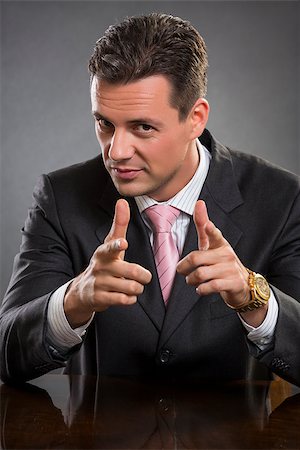 Portrait of successful elegant handsome businessman pointing at you with both index fingers over grey background.. Stock Photo - Budget Royalty-Free & Subscription, Code: 400-07656590