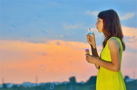 young girl with soap-bubbles in sunset Stock Photo - Budget Royalty-Free & Subscription, Code: 400-07658007