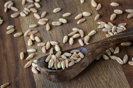 simsearch:400-08428404,k - Loose grains of farro in and around a wooden spoon. Stock Photo - Budget Royalty-Free & Subscription, Code: 400-07658101