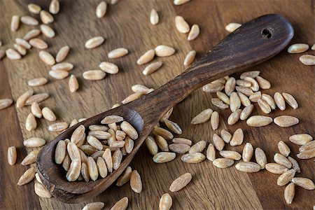 simsearch:400-08428404,k - Loose grains of farro in and around a wooden spoon. Stock Photo - Budget Royalty-Free & Subscription, Code: 400-07658102