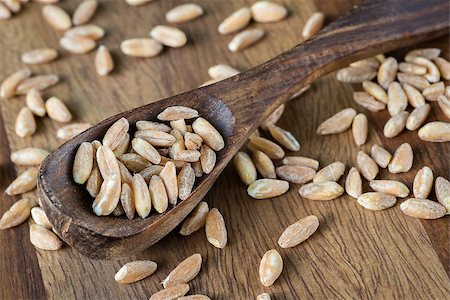 simsearch:400-08428404,k - Loose grains of farro in and around a wooden spoon. Stock Photo - Budget Royalty-Free & Subscription, Code: 400-07658103