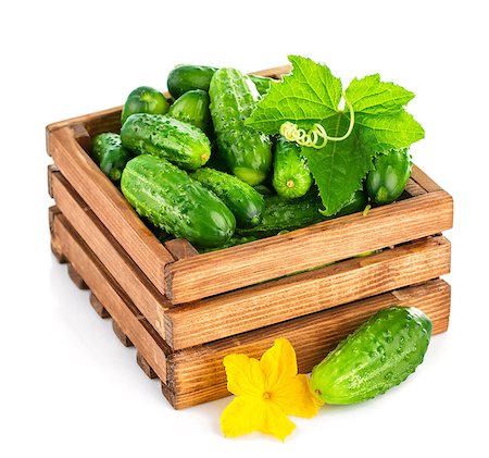 simsearch:400-07667021,k - Fresh cucumber in wooden box with green leaf and flower. Isolated on white background Stock Photo - Budget Royalty-Free & Subscription, Code: 400-07658873