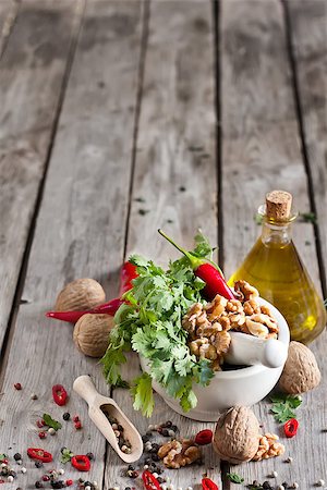 simsearch:400-05678242,k - Cilantro, walnuts and red hot pepper in white ceramic mortar on wooden table. Copy space background. Foto de stock - Super Valor sin royalties y Suscripción, Código: 400-07659071