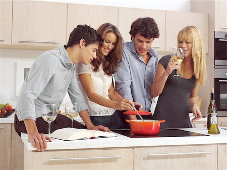 Group Of Young Friends Preparing Breakfast In Modern Kitchen Foto de stock - Super Valor sin royalties y Suscripción, Código: 400-07659823