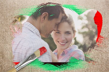 Composite image of happy couple in the countryside against weathered surface with paintbrushes Stock Photo - Budget Royalty-Free & Subscription, Code: 400-07664119