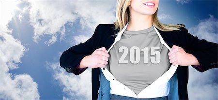 superhero business - Businesswoman opening shirt in superhero style against blue cloudy sky Foto de stock - Super Valor sin royalties y Suscripción, Código: 400-07664920