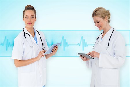 ecg electrodes - Composite image of female medical team against medical background with blue ecg line Stock Photo - Budget Royalty-Free & Subscription, Code: 400-07665089