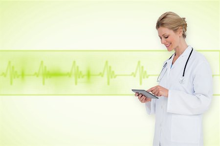 ecg electrodes - Blonde doctor using tablet pc against medical background with green ecg line Stock Photo - Budget Royalty-Free & Subscription, Code: 400-07665109