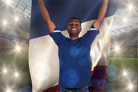 simsearch:400-07665266,k - Cheering football fan in blue jersey holding france flag against large football stadium with lights Stock Photo - Budget Royalty-Free & Subscription, Code: 400-07665214