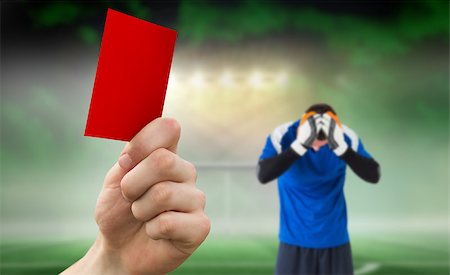 soccer goalie hands - Hand holding up red card against football pitch under spotlights with goalie Stock Photo - Budget Royalty-Free & Subscription, Code: 400-07665257