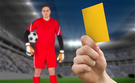 soccer goalie hands - Hand holding up yellow card against football stadium with goalie Stock Photo - Budget Royalty-Free & Subscription, Code: 400-07665263