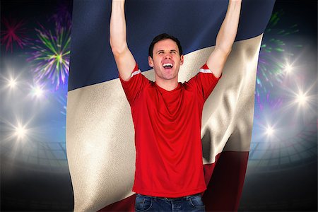 Cheering football fan in red against fireworks exploding over football stadium and france flag Stock Photo - Budget Royalty-Free & Subscription, Code: 400-07665338