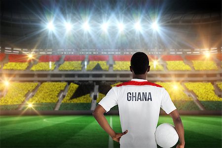 simsearch:400-07665266,k - Ghana football player holding ball against stadium full of ghana football fans Stock Photo - Budget Royalty-Free & Subscription, Code: 400-07665339