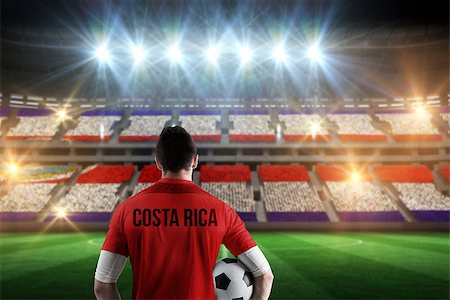 simsearch:400-07665266,k - Costa rica football player holding ball against stadium full of costa rica football fans Stock Photo - Budget Royalty-Free & Subscription, Code: 400-07665349