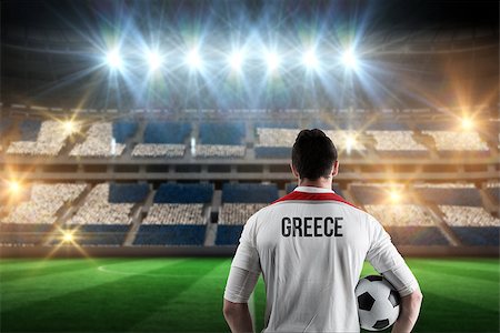 simsearch:400-07665266,k - Greece football player holding ball against stadium full of greece football fans Stock Photo - Budget Royalty-Free & Subscription, Code: 400-07665354