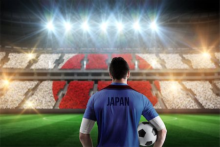 simsearch:400-07665266,k - Japan football player holding ball against stadium full of japan football fans Stock Photo - Budget Royalty-Free & Subscription, Code: 400-07665359