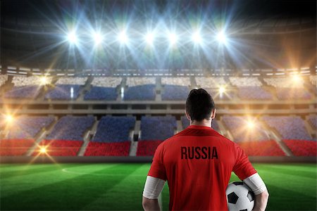 simsearch:400-07665266,k - Russia football player holding ball against stadium full of russia football fans Stock Photo - Budget Royalty-Free & Subscription, Code: 400-07665364