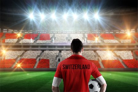 simsearch:400-07665266,k - Swiss football player holding ball against stadium full of swiss football fans Stock Photo - Budget Royalty-Free & Subscription, Code: 400-07665367