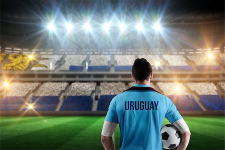 simsearch:400-07665266,k - Uruguay football player holding ball against stadium full of uruguay football fans Stock Photo - Budget Royalty-Free & Subscription, Code: 400-07665368