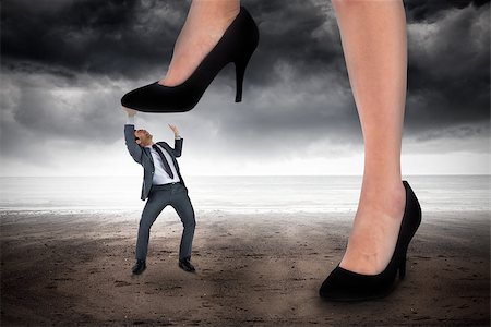 simsearch:400-07665425,k - Composite image of businesswoman stepping on tiny businessman against stormy weather by the sea Stockbilder - Microstock & Abonnement, Bildnummer: 400-07665421