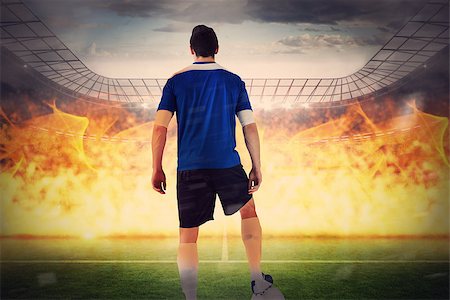 simsearch:400-07665266,k - Handsome football player in blue jersey against large football stadium with lights Stock Photo - Budget Royalty-Free & Subscription, Code: 400-07665490