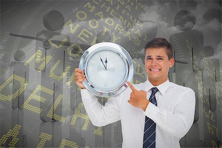 futuristic clock - Anxious businessman holding and showing a clock against airport departures board for india Stock Photo - Budget Royalty-Free & Subscription, Code: 400-07665613