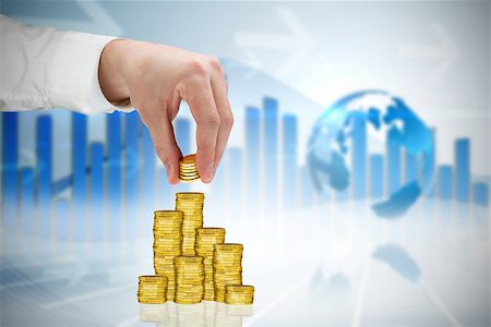 Businessman holding coins against global business graphic in blue Stock Photo - Budget Royalty-Free & Subscription, Code: 400-07665638