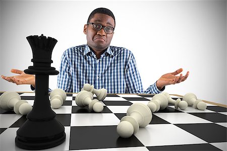 simsearch:400-07665425,k - Composite image of young businessman shrugging shoulders with chessboard Stockbilder - Microstock & Abonnement, Bildnummer: 400-07665698