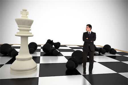 Businessman standing and looking with chessboard against white background with vignette Stock Photo - Budget Royalty-Free & Subscription, Code: 400-07665714
