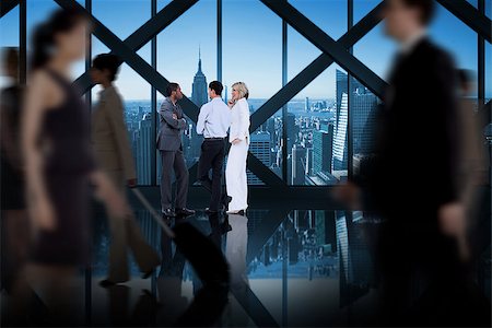 simsearch:400-07665756,k - Business colleagues talking against room with large window looking on city Stock Photo - Budget Royalty-Free & Subscription, Code: 400-07665727