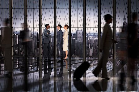 simsearch:400-07665756,k - Business colleagues talking against room with large window looking on city Stock Photo - Budget Royalty-Free & Subscription, Code: 400-07665745