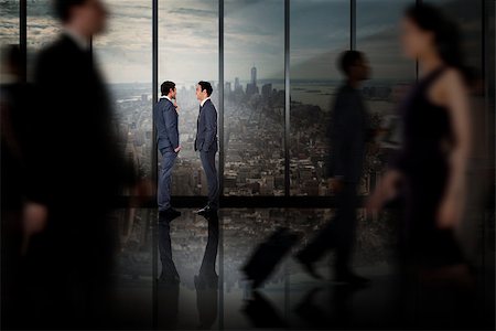 simsearch:400-07665756,k - Businessmen talking against room with large window looking on city Stock Photo - Budget Royalty-Free & Subscription, Code: 400-07665741