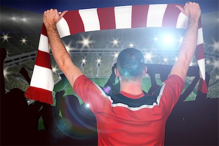 simsearch:400-07665266,k - Football player holding striped scarf against large football stadium with lights Stock Photo - Budget Royalty-Free & Subscription, Code: 400-07665810
