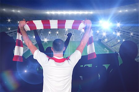 simsearch:400-07665266,k - Football player holding striped scarf against large football stadium with lights Stock Photo - Budget Royalty-Free & Subscription, Code: 400-07665811