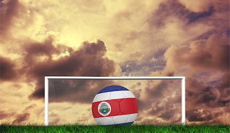 Football in costa rica colours against green grass under cloudy sky Stock Photo - Budget Royalty-Free & Subscription, Code: 400-07665848