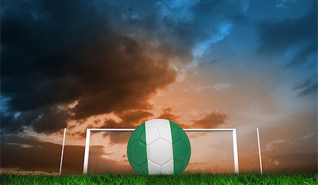 Football in nigeria colours against green grass under blue and orange sky Stock Photo - Budget Royalty-Free & Subscription, Code: 400-07665860