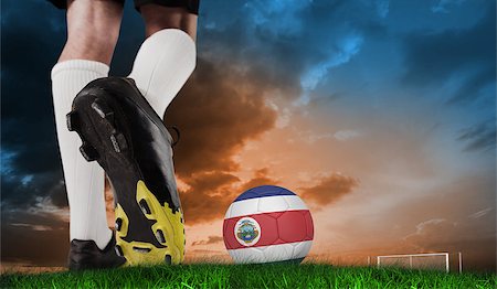 Composite image of football boot kicking costa rica ball against green grass under blue and orange sky Stock Photo - Budget Royalty-Free & Subscription, Code: 400-07666007