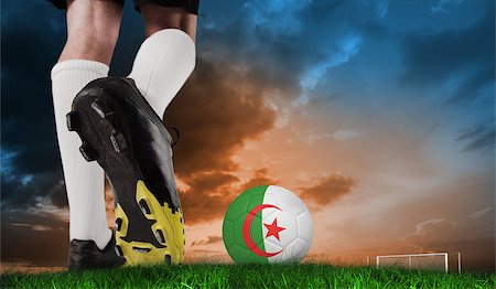 Composite image of football boot kicking algeria ball against green grass under blue and orange sky Stock Photo - Budget Royalty-Free & Subscription, Code: 400-07666010