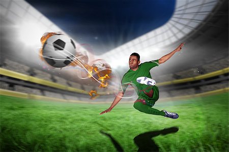 simsearch:400-07665266,k - Football player in green kicking against football pitch in large stadium Stock Photo - Budget Royalty-Free & Subscription, Code: 400-07666157