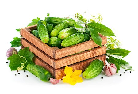 simsearch:400-07667021,k - Fresh cucumbers in wooden box with green leaf and flower. Isolated on white background Stock Photo - Budget Royalty-Free & Subscription, Code: 400-07666987