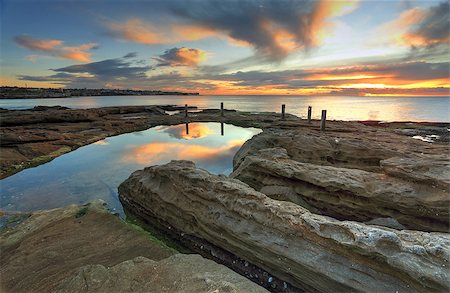simsearch:400-07667033,k - Deep channels have been eroded into the rocks by water running into this natural rock pool, South Coogee, Australia Stock Photo - Budget Royalty-Free & Subscription, Code: 400-07667034